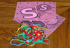 children sewing cards and strings