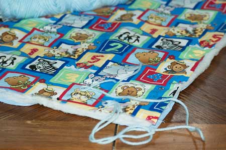 tying baby blanket quilt